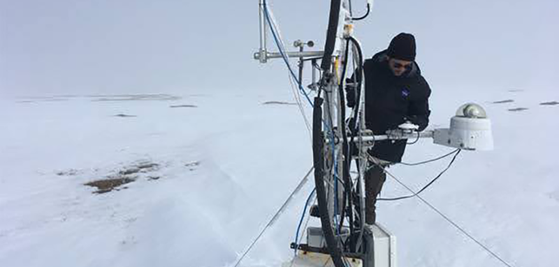 Technician inspecting equipment in Alaska