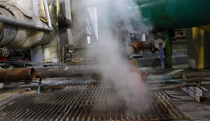 Pipe releasing steam over catwalk